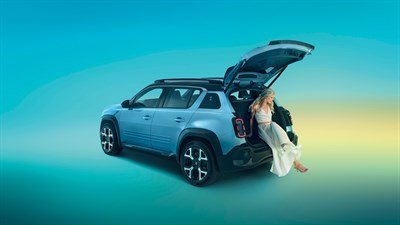 Renault vozilo s otvorenim prtljažnikom, dok osoba sjedi na rubu prtljažnika.








