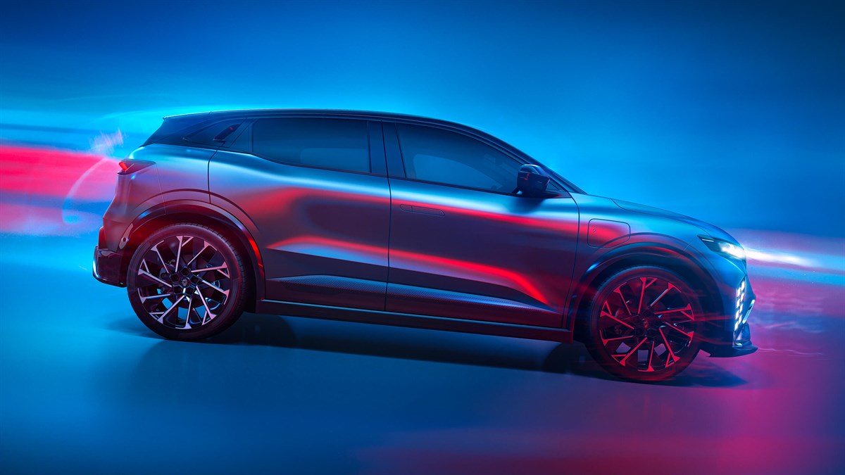 Renault Megane E-Tech electric u vožnji, prikazan iz bočnog kuta uz plavo-crveno osvjetljenje.