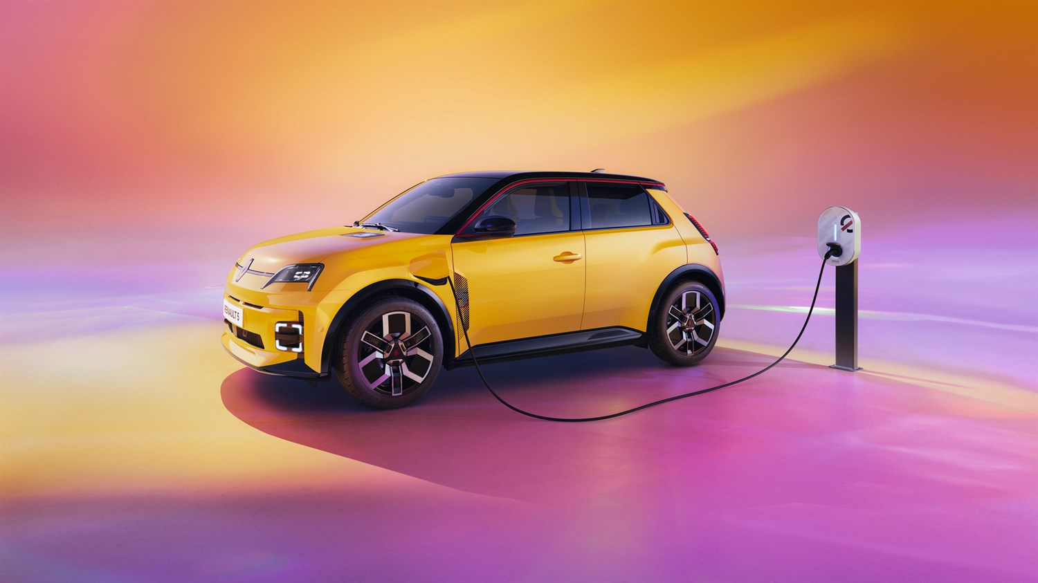 Renault 5 E-Tech Electric u žutoj boji priključen na stanicu za punjenje na šarenoj pozadini








