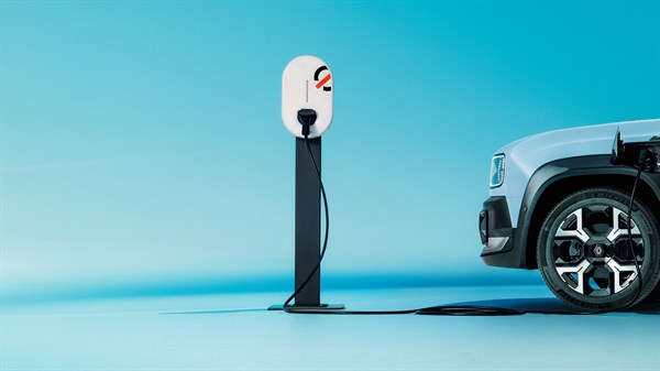 Stanica za punjenje električnog vozila s priključenim kabelom, uz prednji kotač automobila.