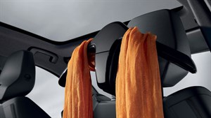 Stražnji dio naslona sjedala u vozilu Renault Austral full hybrid E-Tech s multifunkcionalnom vješalicom i objesenom odjećom.









