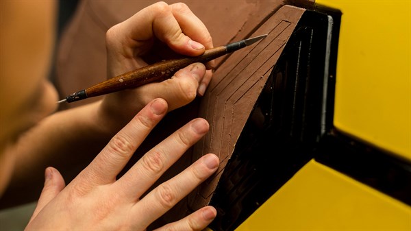 ruke dizajnera koji alatima oblikuje logotip Renault